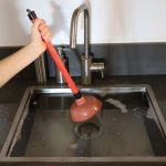 Overflowing kitchen sink, clogged drain