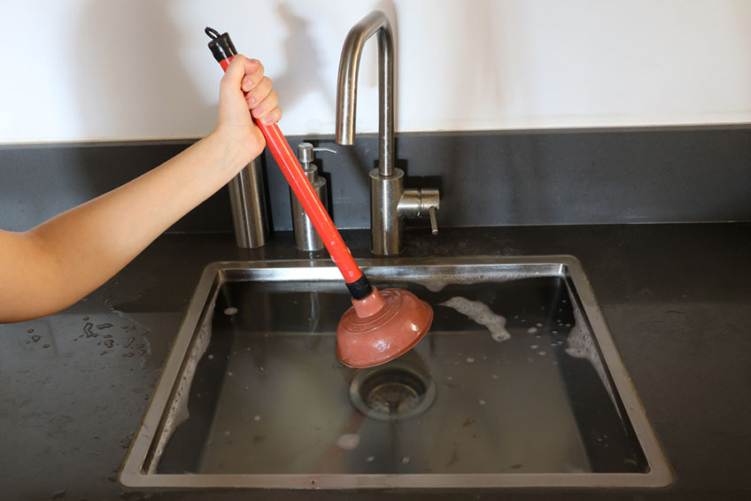 Overflowing kitchen sink, clogged drain