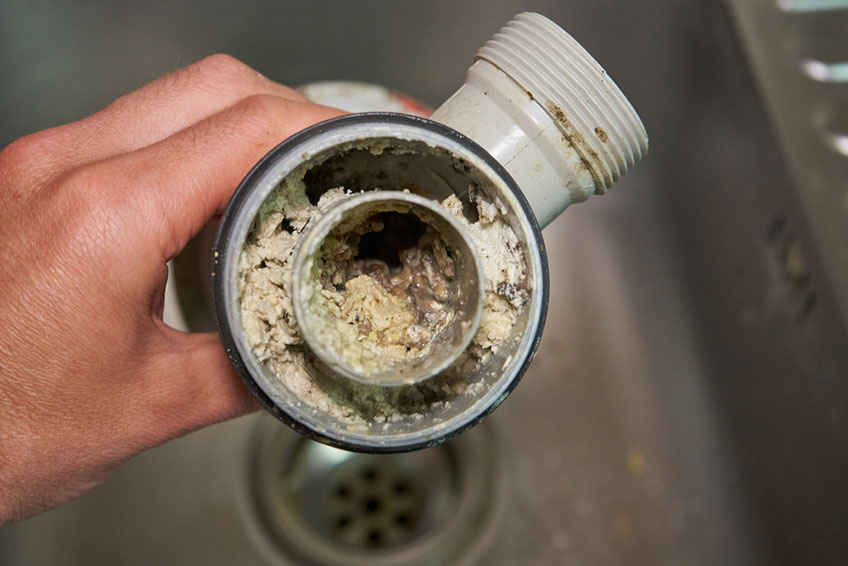 Clogged drain being cleaned