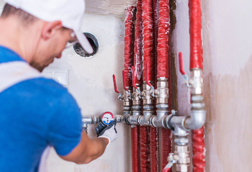Plumber Checking Water Supply System