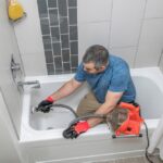 homeowner holding a plumbing snake