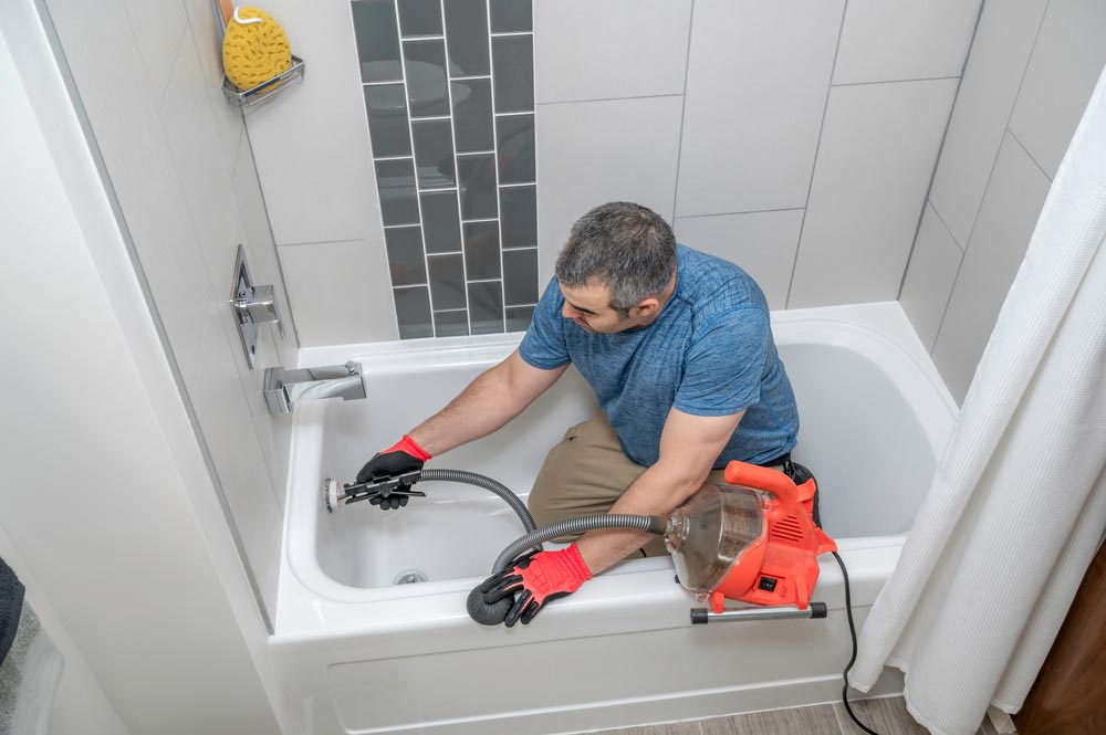 homeowner holding a plumbing snake